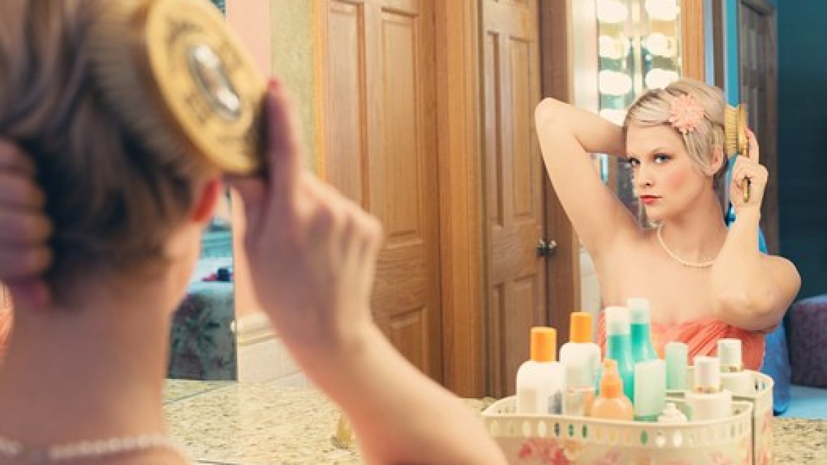 Keep makeup on woman at mirror
