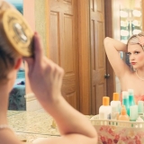 Keep makeup on woman at mirror
